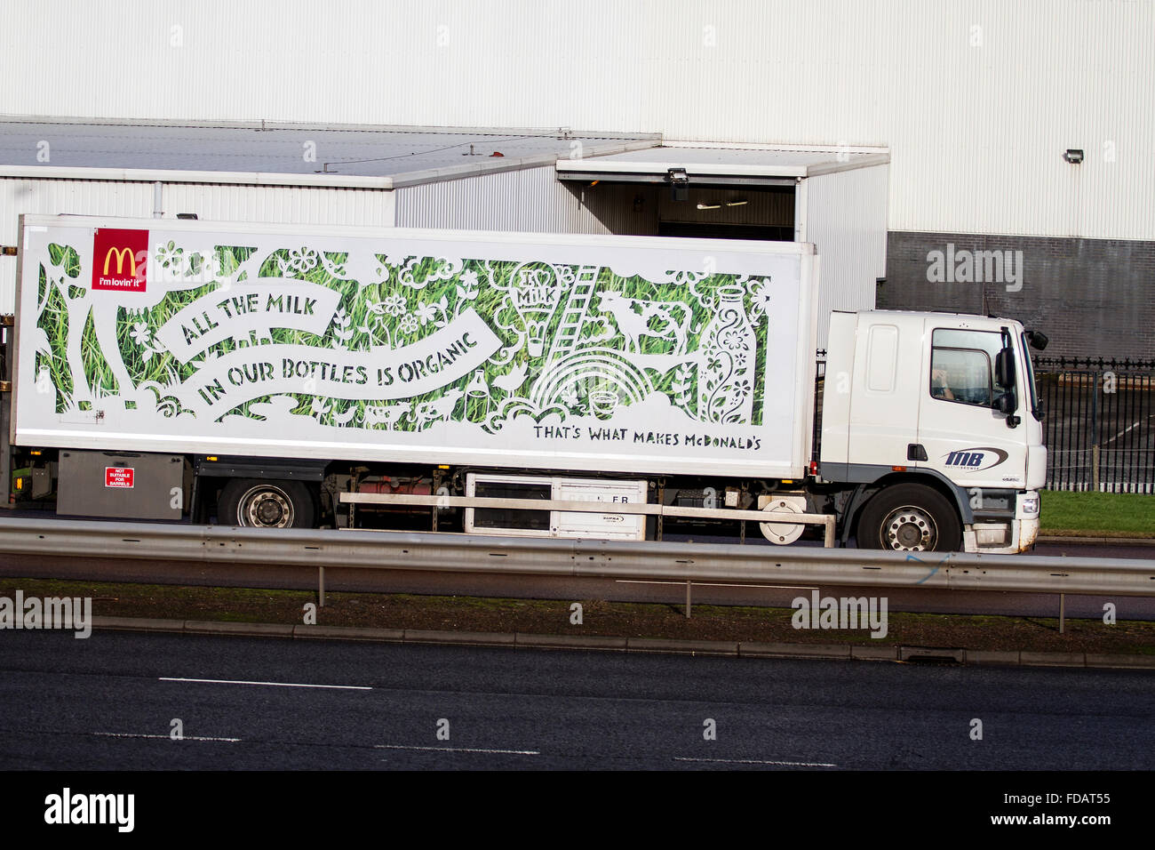 A McDonald`s lorry advertising 'All The Milk In Our Bottles Is Organic' travelling along the dual carriageway in Dundee, UK Stock Photo